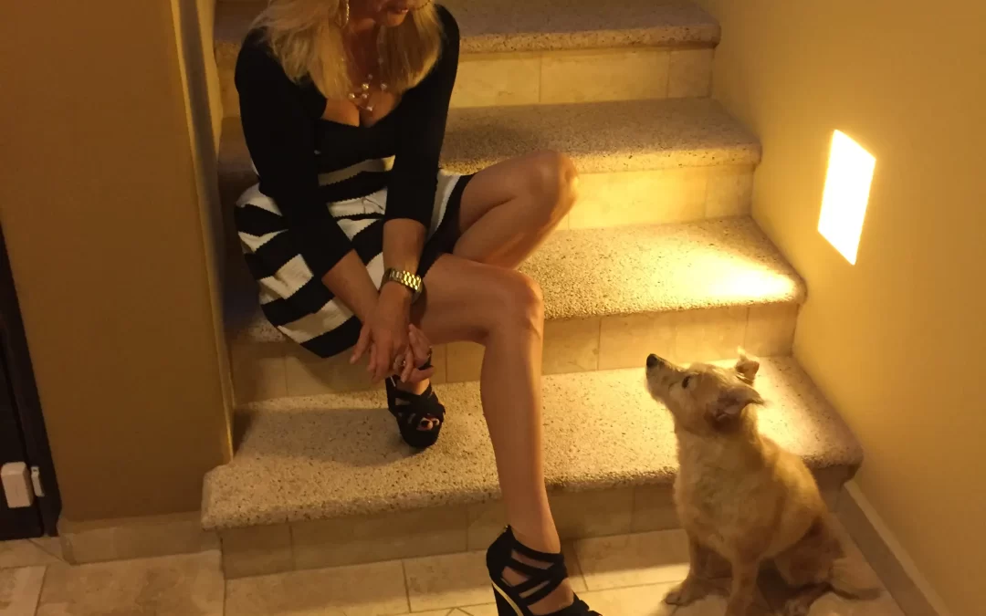 Sandra J Wilson on her 52nd birthday sits on the stairs looking down at her rescue dog Boo who is looking up at her.